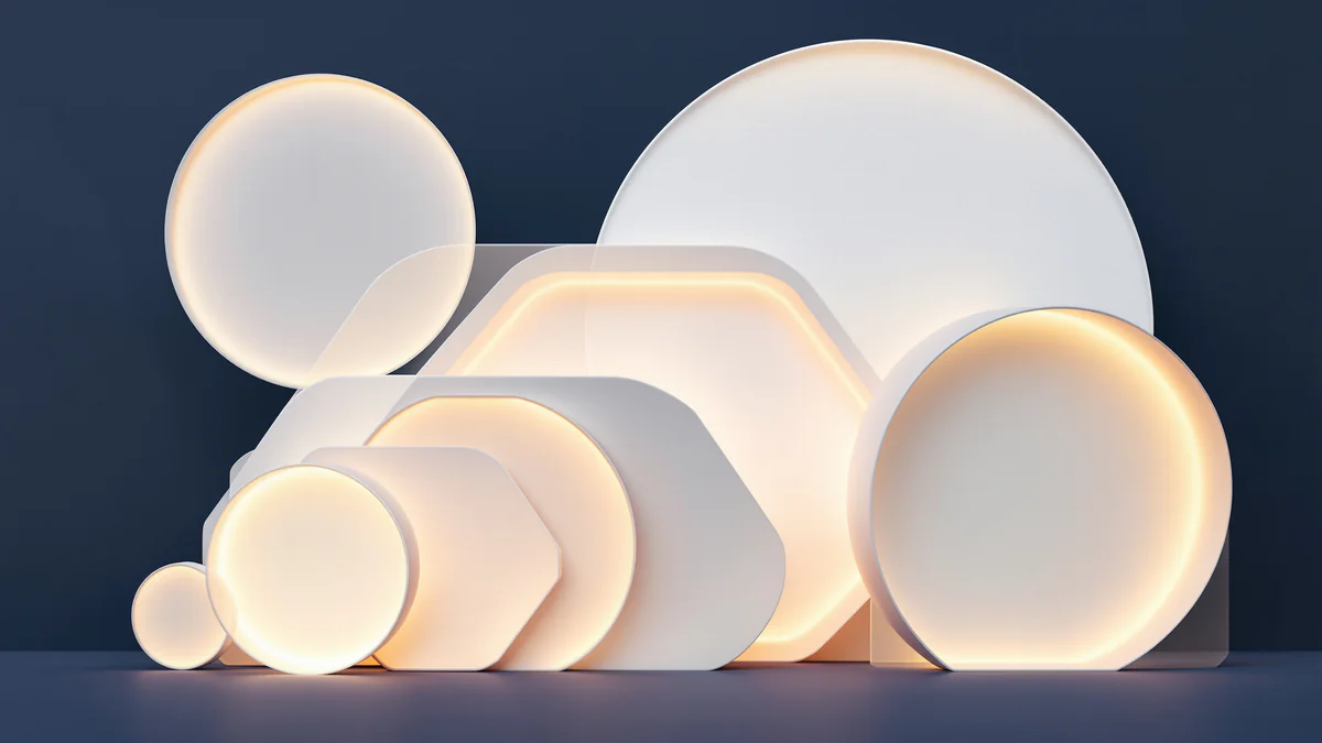 Ascending geometric shapes in varying sizes representing developmental milestones, illuminated with soft warm lighting against a dark navy background.