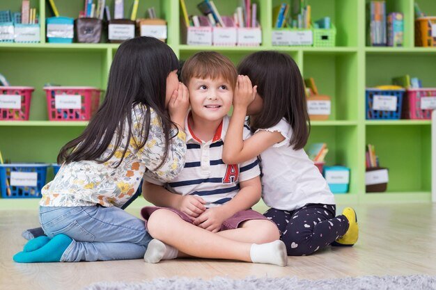 girls-whispering-ears-boy